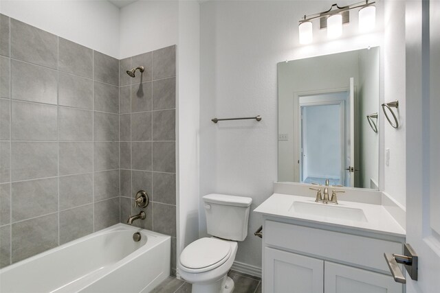 bathroom with vanity, toilet, and shower / washtub combination