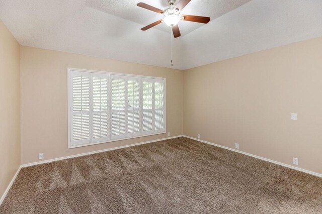 carpeted empty room with baseboards and ceiling fan