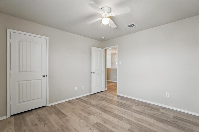 unfurnished bedroom with visible vents, a ceiling fan, baseboards, and light wood-type flooring