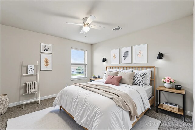 carpeted bedroom with visible vents, a ceiling fan, and baseboards