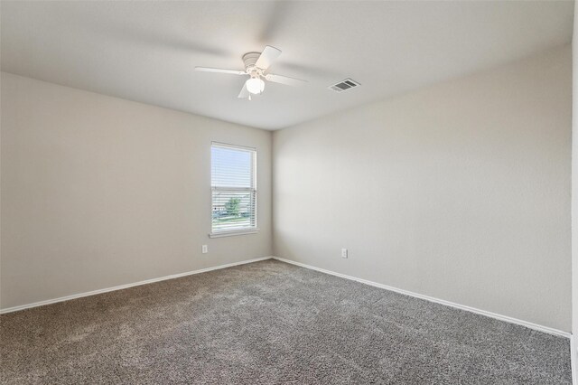 unfurnished room featuring carpet floors, baseboards, a ceiling fan, and visible vents