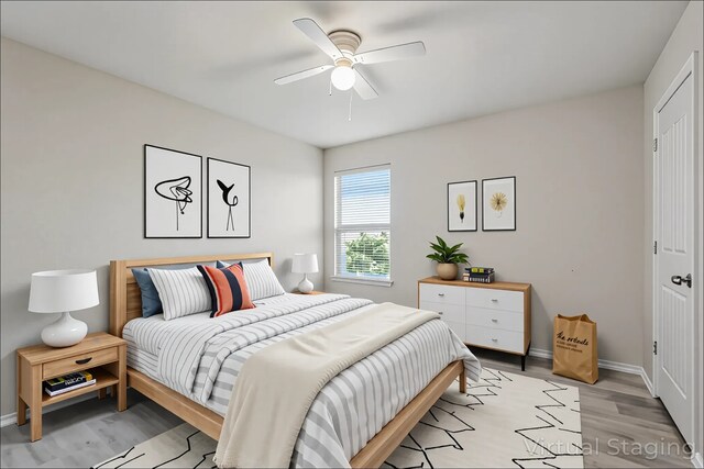 bedroom featuring baseboards, ceiling fan, and light wood finished floors