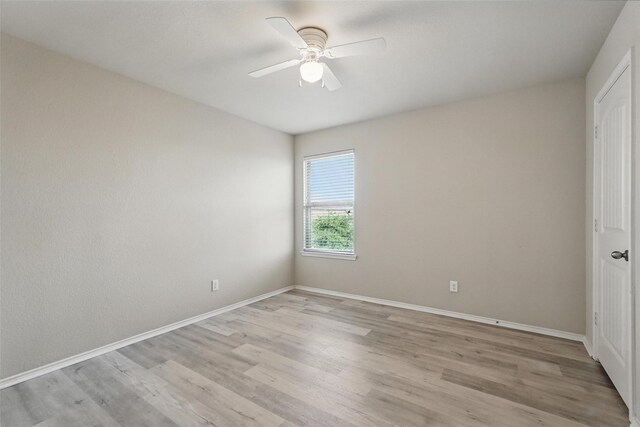 spare room with ceiling fan, baseboards, and light wood finished floors