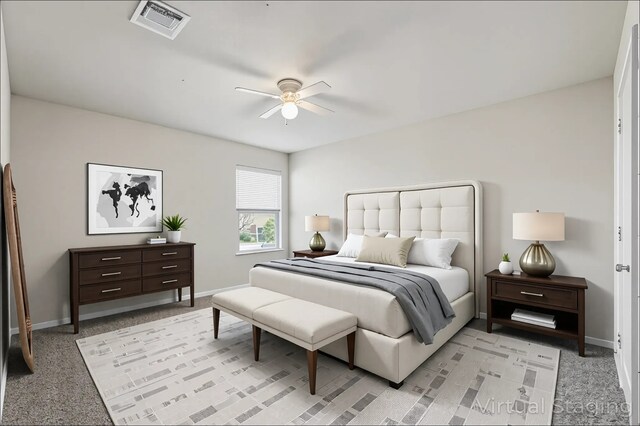 bedroom featuring light colored carpet, baseboards, visible vents, and ceiling fan