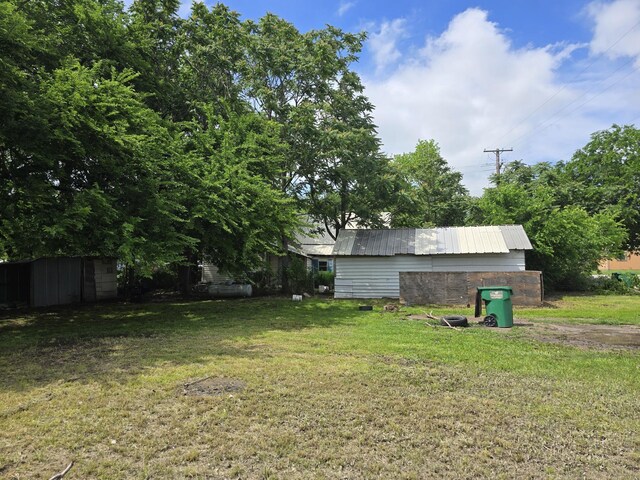 view of yard featuring an outbuilding and a shed