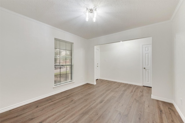 913 Vince Ln, Desoto, TX 75115 - empty room with a textured ceiling, ornamental molding, baseboards, and light wood-style flooring