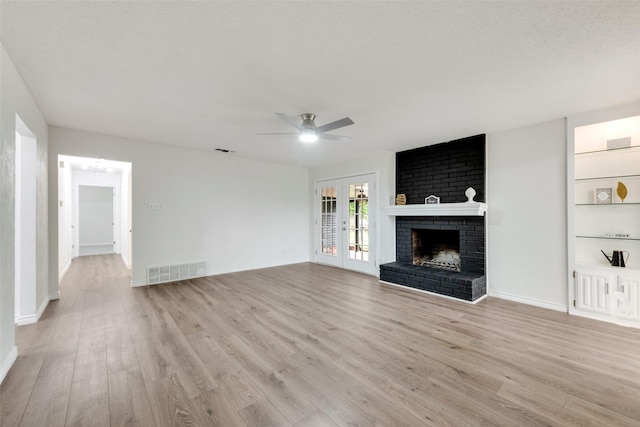 913 Vince Ln, Desoto, TX 75115 - unfurnished living room with a fireplace, a ceiling fan, light wood-type flooring, and visible vents