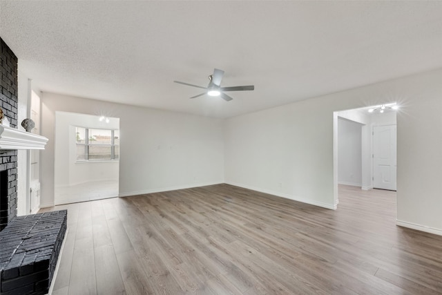 913 Vince Ln, Desoto, TX 75115 - unfurnished living room featuring baseboards, ceiling fan, a brick fireplace, and wood finished floors
