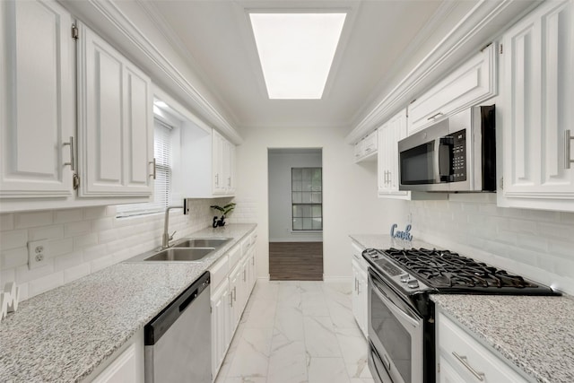 913 Vince Ln, Desoto, TX 75115 - kitchen with light stone counters, a sink, marble finish floor, stainless steel appliances, and white cabinetry