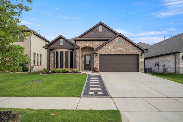 1248 Starlight Ave, Aubrey, TX 76227 - french country home featuring brick siding, an attached garage, concrete driveway, cooling unit, and a front yard