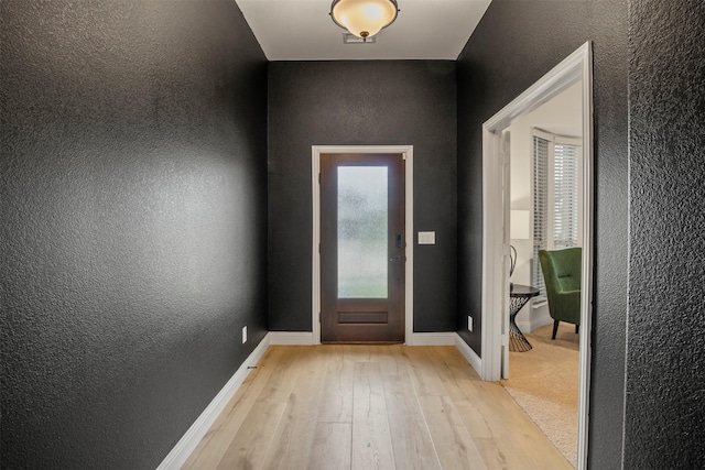 1248 Starlight Ave, Aubrey, TX 76227 - foyer entrance featuring a textured wall, light wood-type flooring, and baseboards