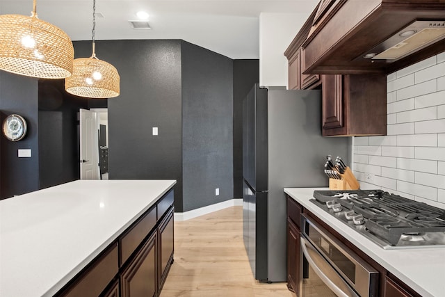 1248 Starlight Ave, Aubrey, TX 76227 - kitchen with appliances with stainless steel finishes, custom exhaust hood, light countertops, and light wood-type flooring