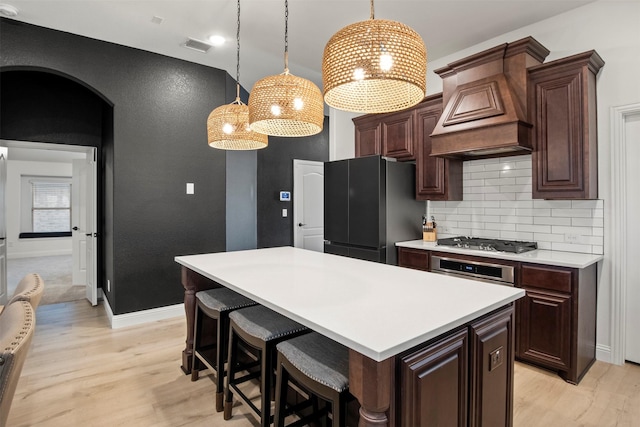 1248 Starlight Ave, Aubrey, TX 76227 - kitchen featuring appliances with stainless steel finishes, custom range hood, light wood-style flooring, and light countertops