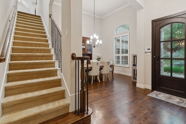 2206 Glasgow Dr, Trophy Club, TX 76262 - entrance foyer with crown molding, a chandelier, stairs, baseboards, and dark wood-style floors