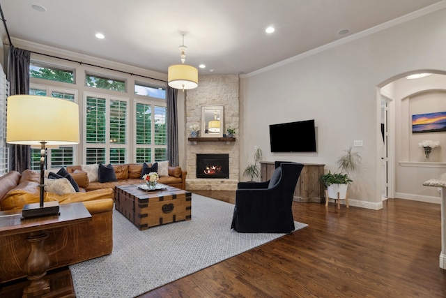 2206 Glasgow Dr, Trophy Club, TX 76262 - living room with ornamental molding, arched walkways, wood finished floors, a stone fireplace, and baseboards