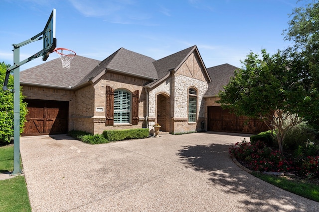 2206 Glasgow Dr, Trophy Club, TX 76262 - french country inspired facade with an attached garage, driveway, and roof with shingles