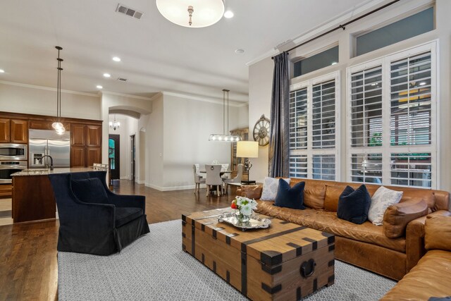 2206 Glasgow Dr, Trophy Club, TX 76262 - living room with dark wood finished floors, arched walkways, crown molding, recessed lighting, and baseboards