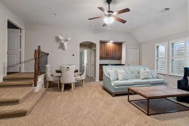 2206 Glasgow Dr, Trophy Club, TX 76262 - living area with arched walkways, a ceiling fan, light carpet, vaulted ceiling, and baseboards