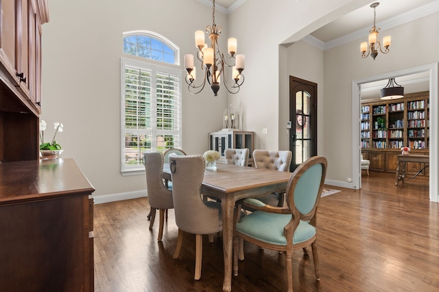 2206 Glasgow Dr, Trophy Club, TX 76262 - dining space featuring a chandelier, crown molding, wood finished floors, arched walkways, and baseboards