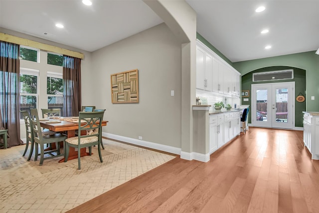 3213 Timberline Dr, Melissa, TX 75454 - dining room featuring arched walkways, baseboards, recessed lighting, and light wood finished floors