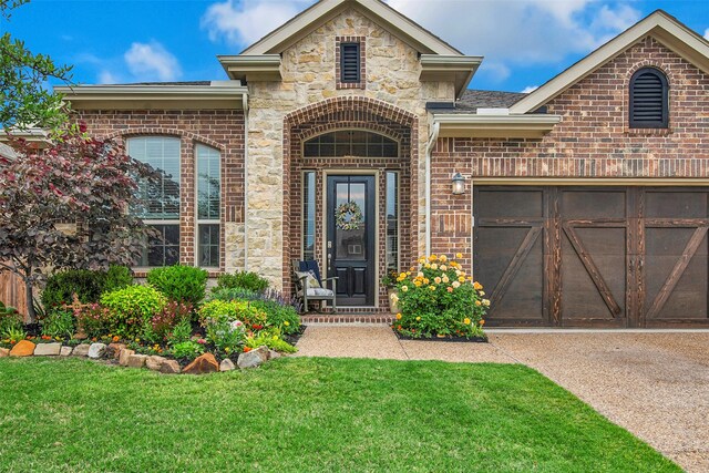 3213 Timberline Dr, Melissa, TX 75454 - entrance to property with an attached garage, stone siding, brick siding, a lawn, and driveway
