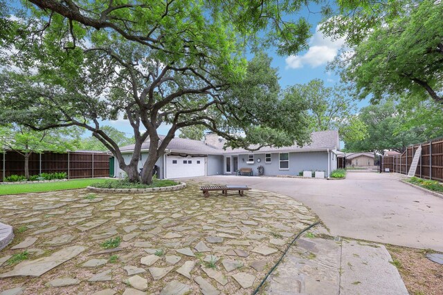 exterior space with a garage, fence, and driveway