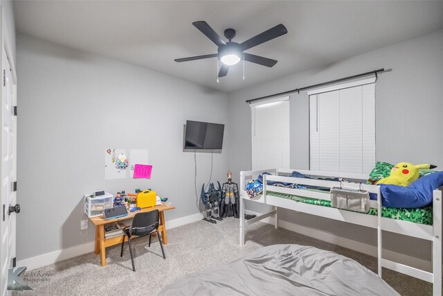 carpeted bedroom with baseboards and ceiling fan