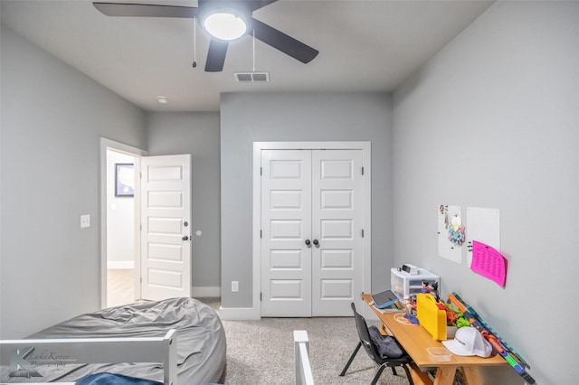 bedroom with a ceiling fan, visible vents, baseboards, a closet, and light carpet