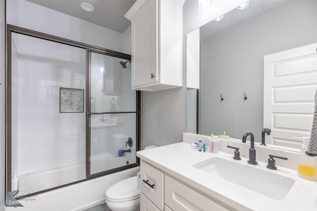full bath featuring shower / bath combination with glass door, toilet, and vanity