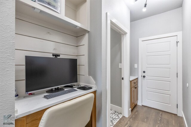 interior space with baseboards and light wood-style flooring