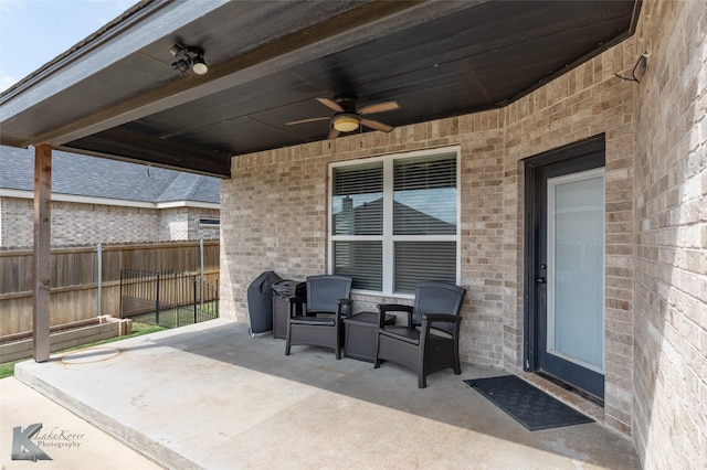 view of patio / terrace featuring fence and a ceiling fan