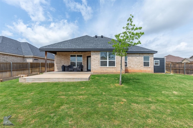 rear view of house featuring brick siding, a patio, a shingled roof, and a fenced backyard
