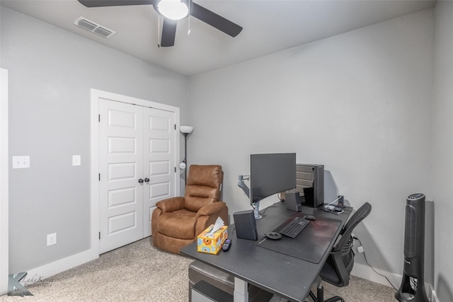 carpeted home office featuring ceiling fan, visible vents, and baseboards