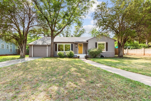single story home with fence, an attached garage, driveway, and a front yard