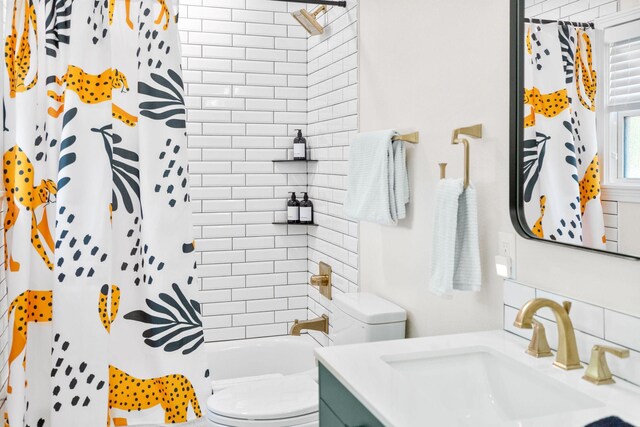 full bath with vanity, decorative backsplash, toilet, and shower / tub combo with curtain