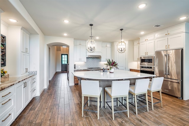 13845 Marys Ridge Rd, Fort Worth, TX 76008 - kitchen featuring visible vents, arched walkways, dark wood-style floors, and stainless steel appliances