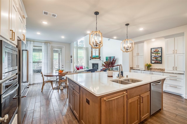13845 Marys Ridge Rd, Fort Worth, TX 76008 - kitchen featuring visible vents, a sink, light countertops, a notable chandelier, and stainless steel appliances