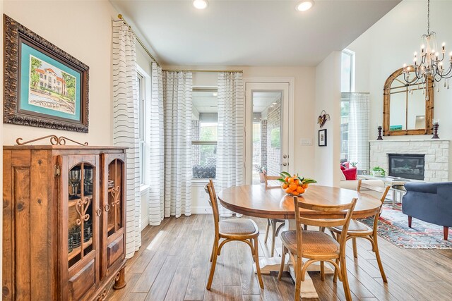 13845 Marys Ridge Rd, Fort Worth, TX 76008 - dining space with a stone fireplace, recessed lighting, light wood-style floors, and a chandelier