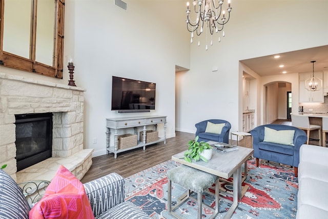 13845 Marys Ridge Rd, Fort Worth, TX 76008 - living area featuring visible vents, arched walkways, wood finished floors, baseboards, and a chandelier