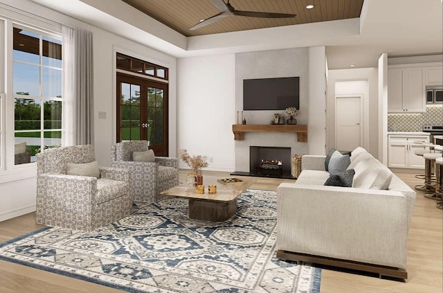 OttoTBD Thompson Road, Weatherford, TX 76087 - living room featuring a raised ceiling, light wood finished floors, a fireplace, and ceiling fan