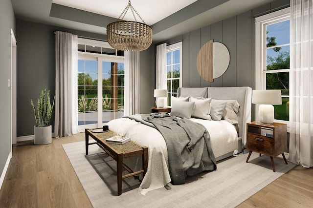 OttoTBD Thompson Road, Weatherford, TX 76087 - bedroom with baseboards, multiple windows, light wood-style flooring, and a notable chandelier