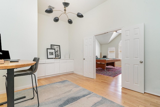 home office featuring a chandelier, baseboards, visible vents, and light wood-type flooring