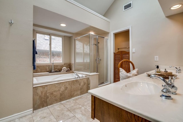 bathroom featuring vanity, a stall shower, a garden tub, and visible vents