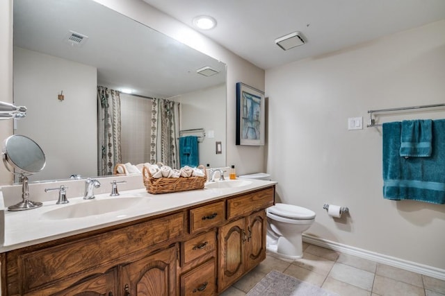 bathroom featuring toilet, tile patterned floors, visible vents, and a sink