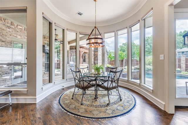 dining room with a healthy amount of sunlight, baseboards, wood finished floors, and a notable chandelier