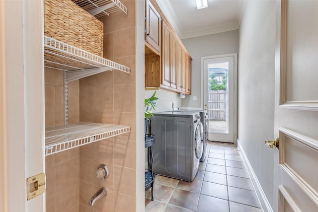 laundry area featuring crown molding, laundry area, baseboards, separate washer and dryer, and light tile patterned floors