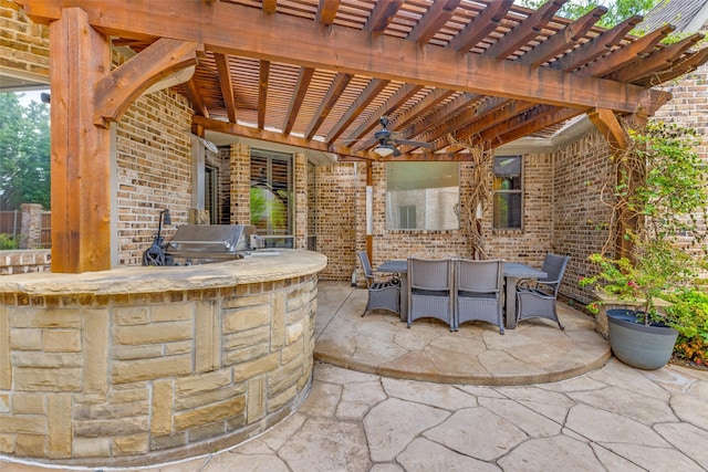 view of patio with area for grilling, a pergola, and outdoor dining area
