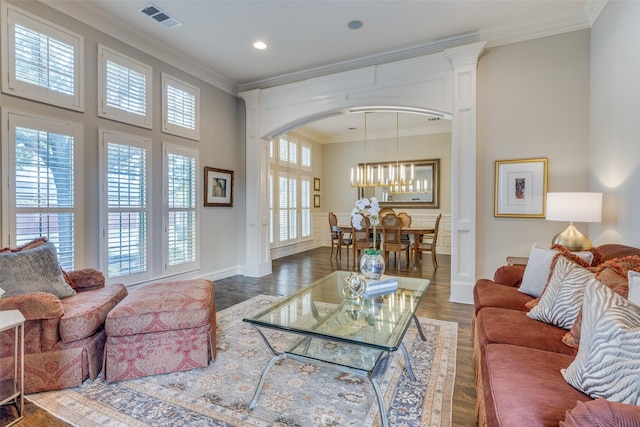 living room with arched walkways, recessed lighting, wood finished floors, visible vents, and ornamental molding