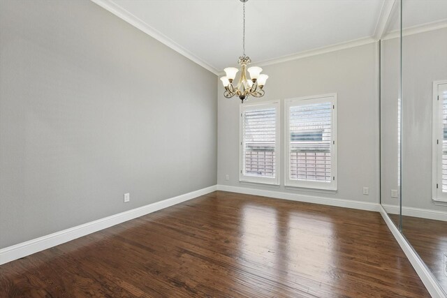 unfurnished dining area featuring crown molding, baseboards, dark wood-style flooring, and a chandelier