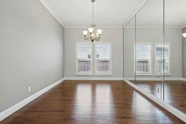 unfurnished dining area featuring crown molding, wood finished floors, and a notable chandelier